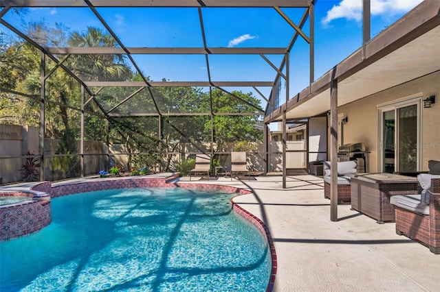 view of pool with a lanai, a patio area, a fenced backyard, and a pool with connected hot tub