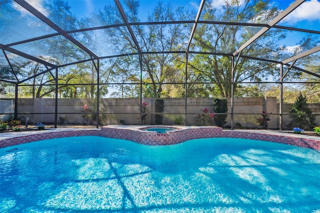 view of swimming pool with an in ground hot tub, fence, and glass enclosure