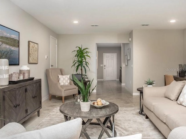 living room with baseboards, visible vents, and recessed lighting