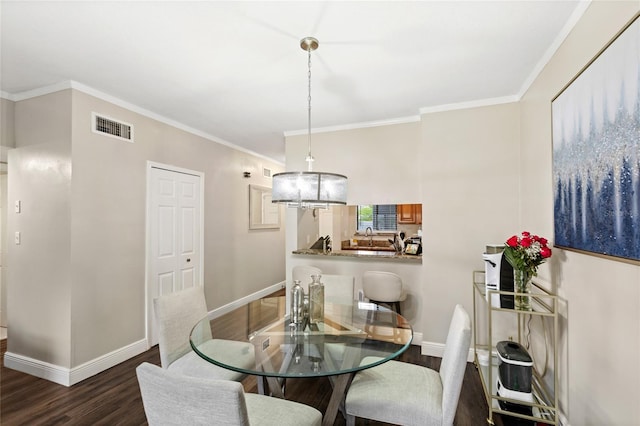 dining area featuring dark wood-style floors, visible vents, crown molding, and baseboards