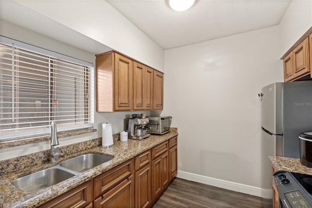 kitchen with light stone counters, electric stove, dark wood finished floors, a sink, and baseboards