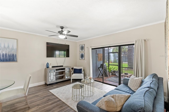 living area featuring ceiling fan, crown molding, baseboards, and wood finished floors