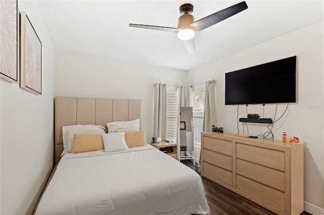 bedroom with ceiling fan and dark wood finished floors