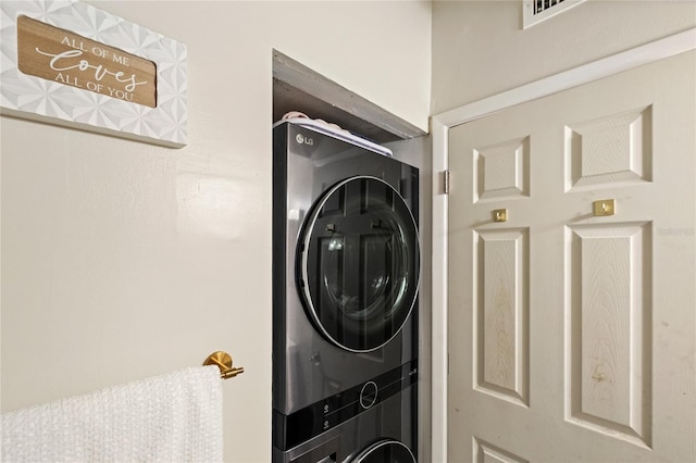 laundry area featuring stacked washer and dryer and laundry area