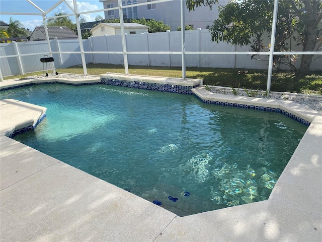 view of pool featuring glass enclosure, a fenced backyard, a fenced in pool, and a patio