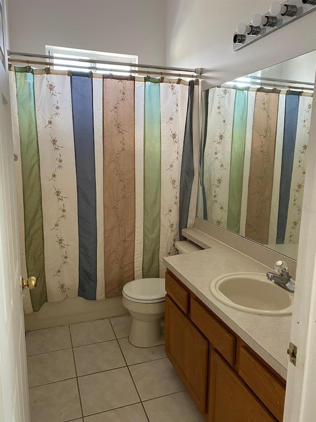 bathroom with vanity, curtained shower, tile patterned flooring, and toilet