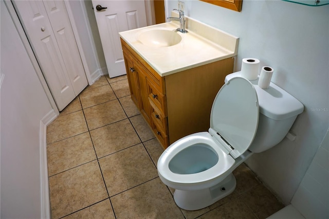 bathroom featuring vanity, toilet, and tile patterned floors