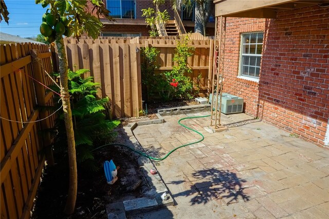 view of patio / terrace featuring a fenced backyard and central AC unit