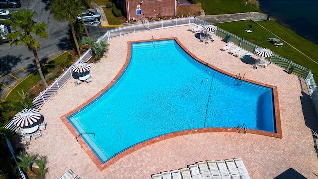 pool with fence and a patio