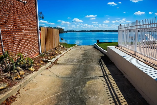 property view of water featuring fence