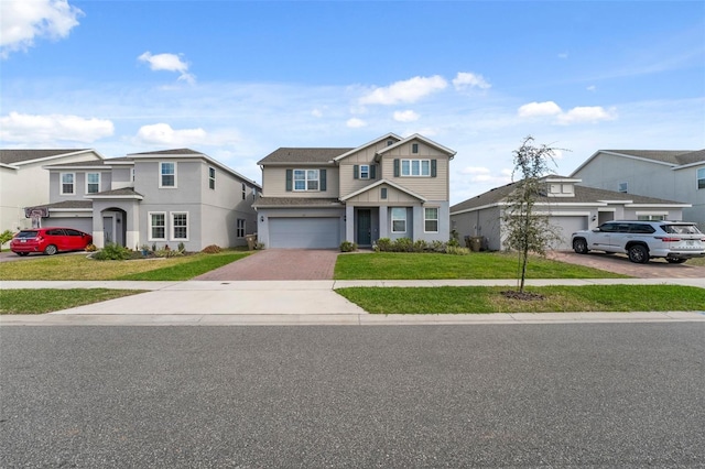 view of front of home featuring board and batten siding, a front yard, decorative driveway, and an attached garage