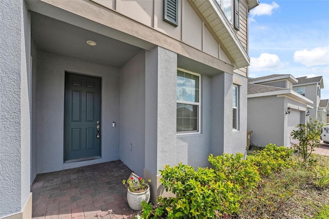 entrance to property with stucco siding