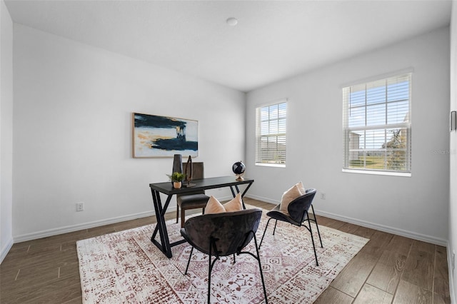 office area with baseboards and wood finished floors