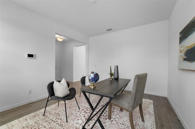 office featuring wood finished floors, visible vents, and baseboards