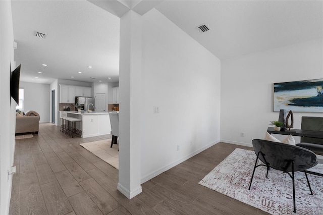 home office with baseboards, visible vents, wood finished floors, and recessed lighting