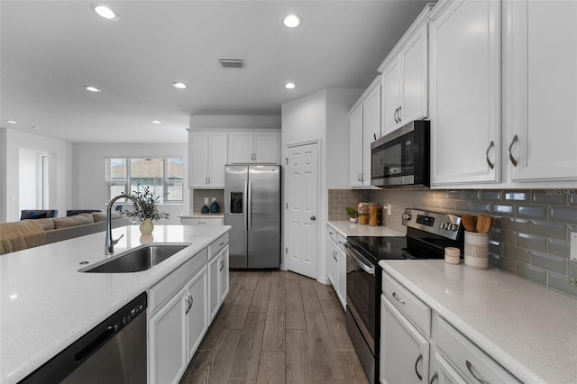 kitchen featuring a sink, visible vents, white cabinetry, appliances with stainless steel finishes, and dark wood-style floors