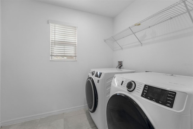 laundry room with laundry area, baseboards, and washer and clothes dryer