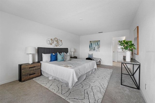 carpeted bedroom with visible vents and baseboards