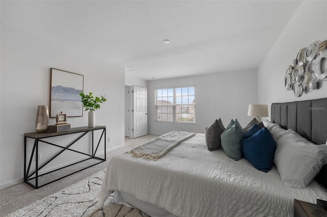 carpeted bedroom featuring baseboards