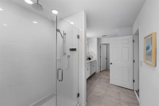 bathroom with a shower stall and vanity