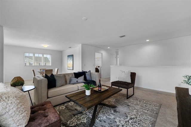 living area featuring recessed lighting, carpet floors, visible vents, baseboards, and washer / clothes dryer