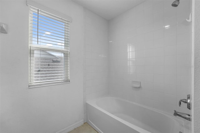 bathroom featuring shower / bath combination and baseboards