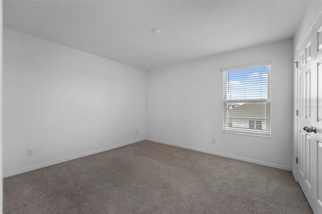 unfurnished bedroom featuring carpet flooring and baseboards