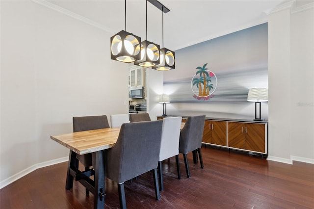 dining room featuring dark wood-style flooring, crown molding, and baseboards