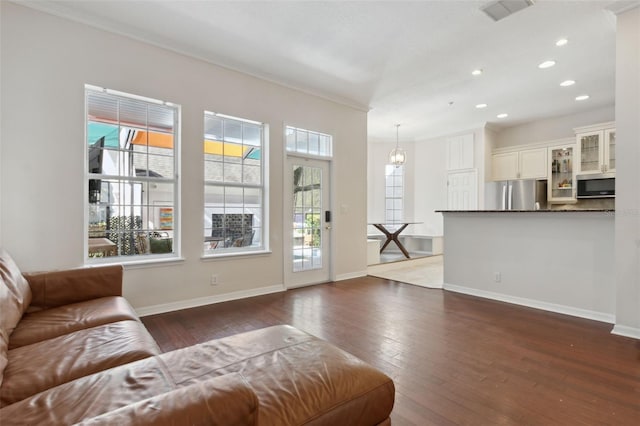 unfurnished living room featuring dark wood finished floors, visible vents, and baseboards