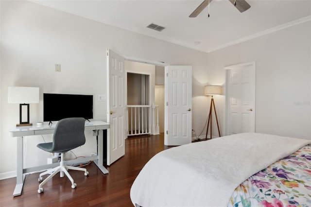 bedroom featuring dark wood-style floors, baseboards, visible vents, and crown molding