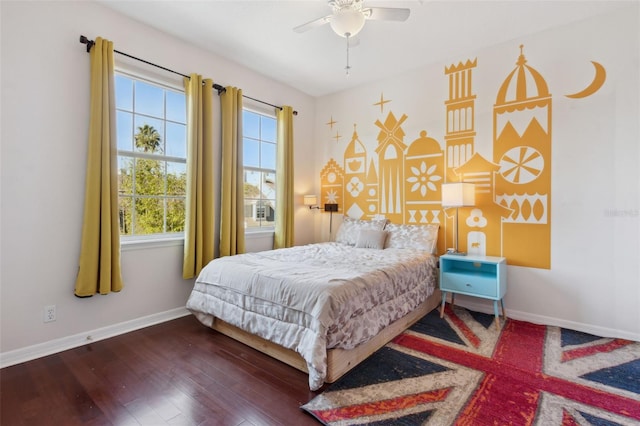 bedroom with ceiling fan, wood finished floors, and baseboards