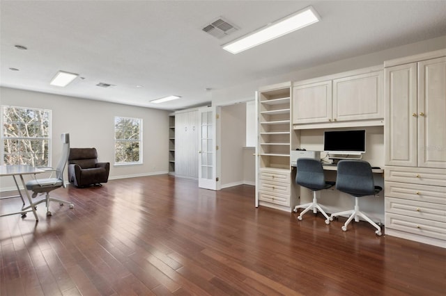 office with dark wood finished floors, visible vents, and baseboards