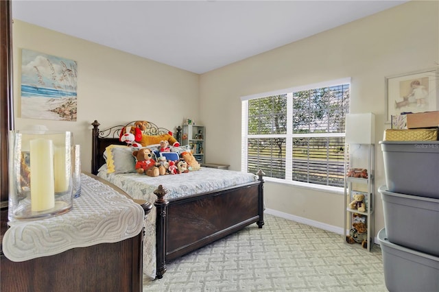 bedroom featuring light carpet and baseboards