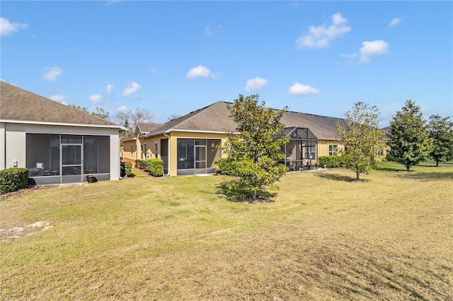 back of property featuring a lawn and a lanai