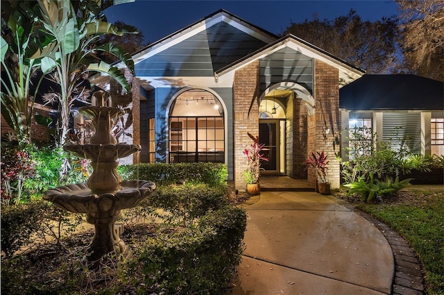 exterior entry at twilight with brick siding