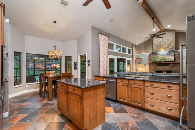 kitchen featuring stone tile floors, visible vents, stainless steel dishwasher, a sink, and beamed ceiling