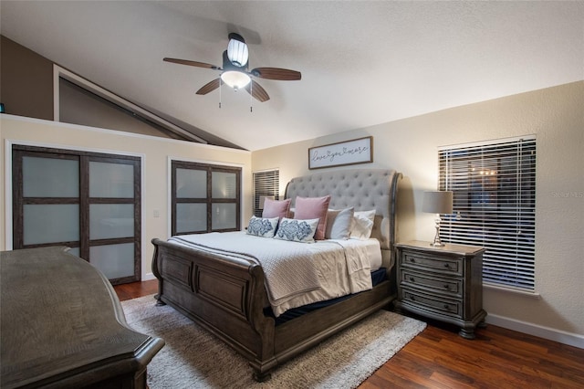 bedroom with lofted ceiling, ceiling fan, dark wood finished floors, and baseboards