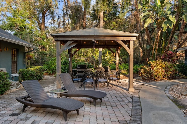 view of patio / terrace with outdoor dining area and a gazebo