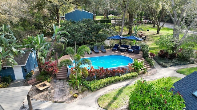 outdoor pool with an outdoor hangout area