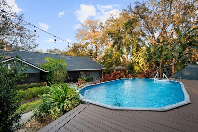 outdoor pool with a wooden deck