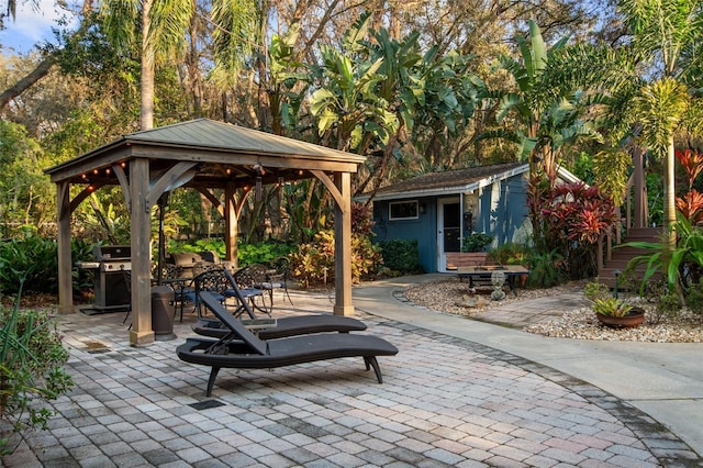 view of patio with a grill and an outdoor structure