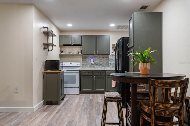 kitchen with electric range, gray cabinets, and visible vents