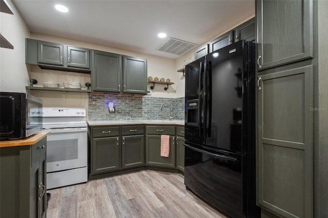 kitchen featuring white range with electric stovetop, open shelves, visible vents, black refrigerator with ice dispenser, and butcher block countertops