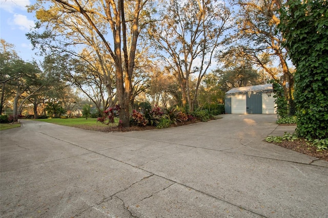 exterior space with a detached garage and an outbuilding