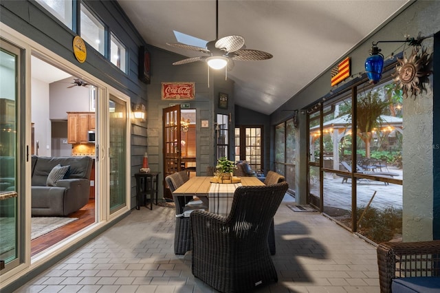 sunroom / solarium featuring vaulted ceiling with skylight and ceiling fan