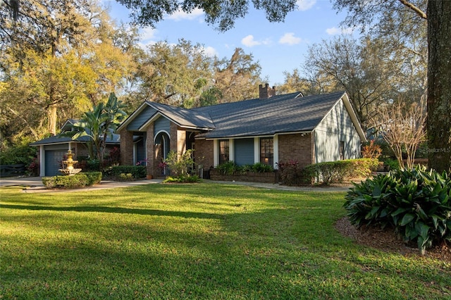 single story home featuring a garage, a chimney, a front lawn, and brick siding