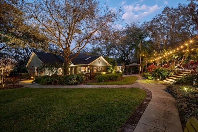 view of front facade featuring a front lawn and a gazebo