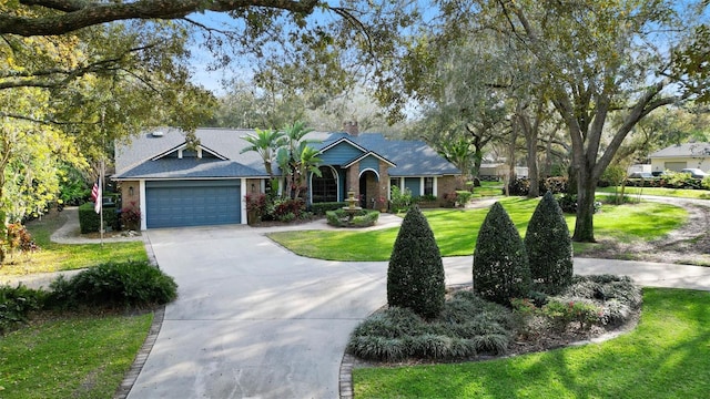 ranch-style home with a garage, a front yard, concrete driveway, and brick siding