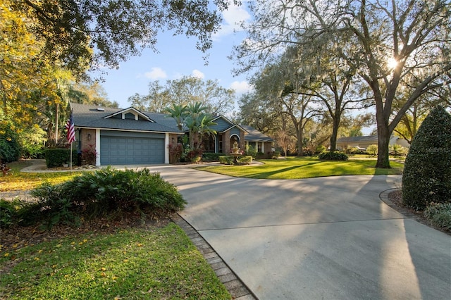 ranch-style house featuring driveway, an attached garage, and a front yard