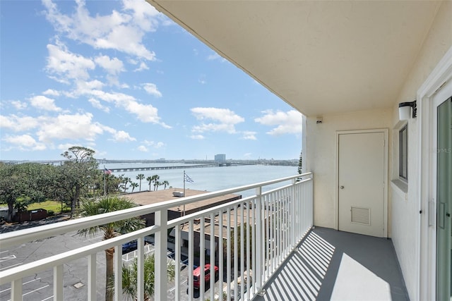 balcony with a water view and visible vents